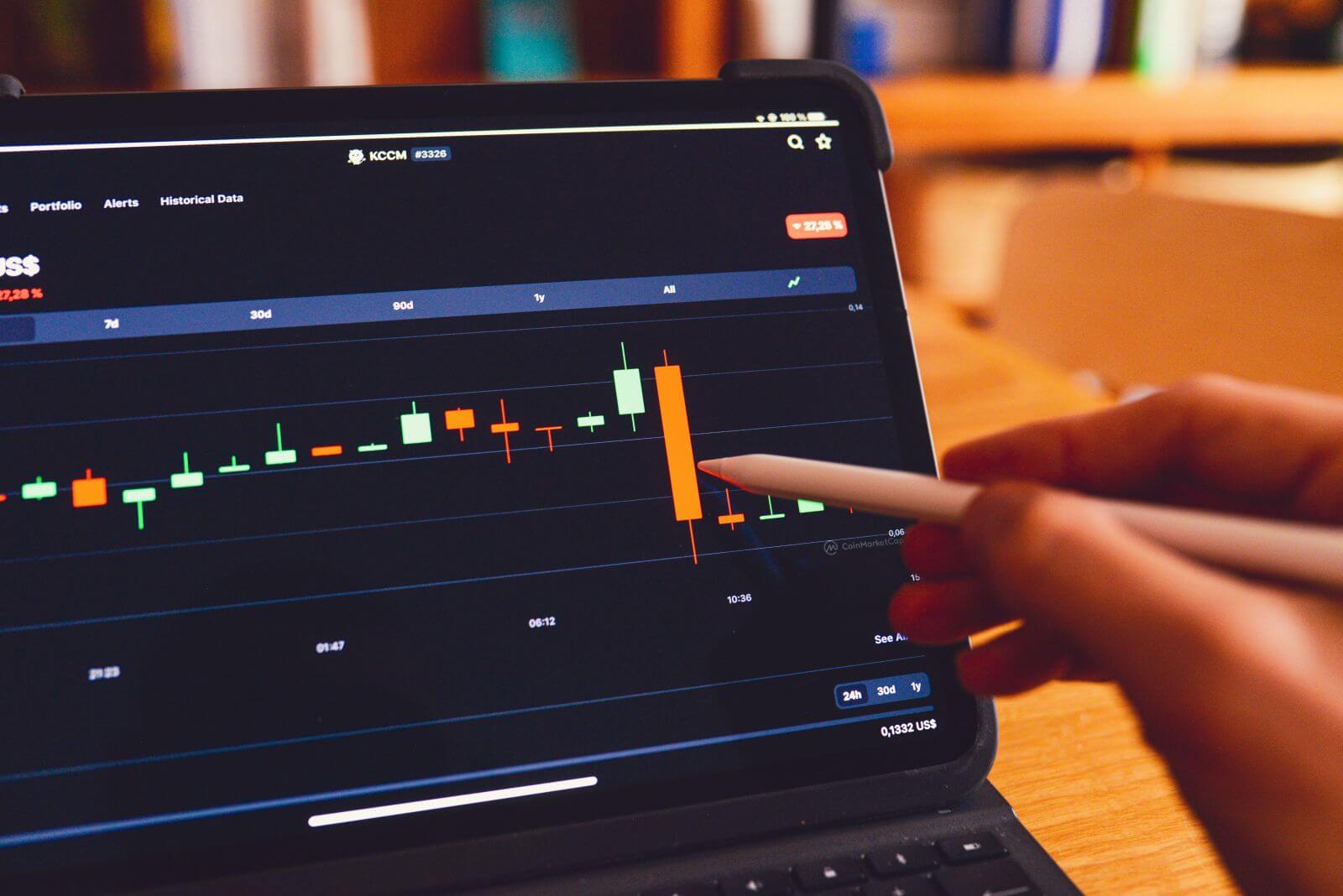 Trader analyzing a barchart by rc_xyz NFT gallery via Unsplash